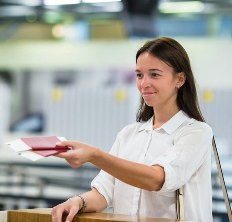 Beautiful woman at the front desk at airport waiting boarding