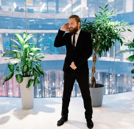 Confident security guard standing in business center