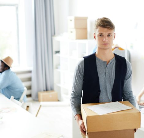 Courier holding parcel at office