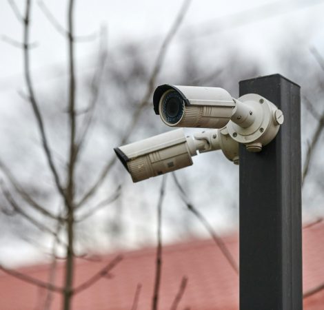 IP CCTV security camera on pole, urban cityscape