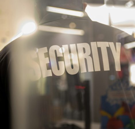 Security guard standing inside commercial building nearby the wi